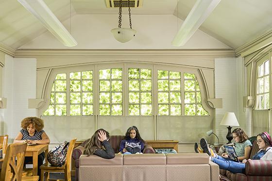 Photo of a group of Chatham University students relaxing and studying in a lounge